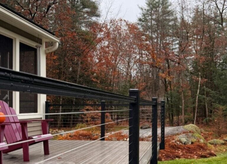 Crowe Fence & Deck wire fence on wooden deck green grass big white house