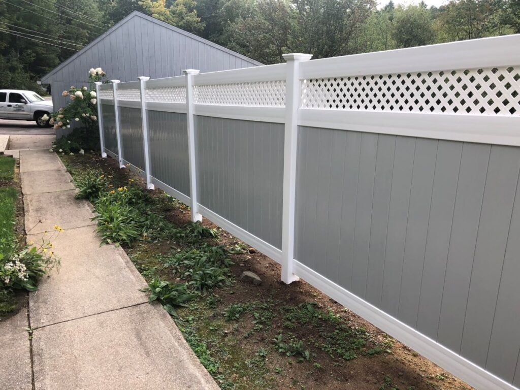 Grey vinyl fence with white lattice topper