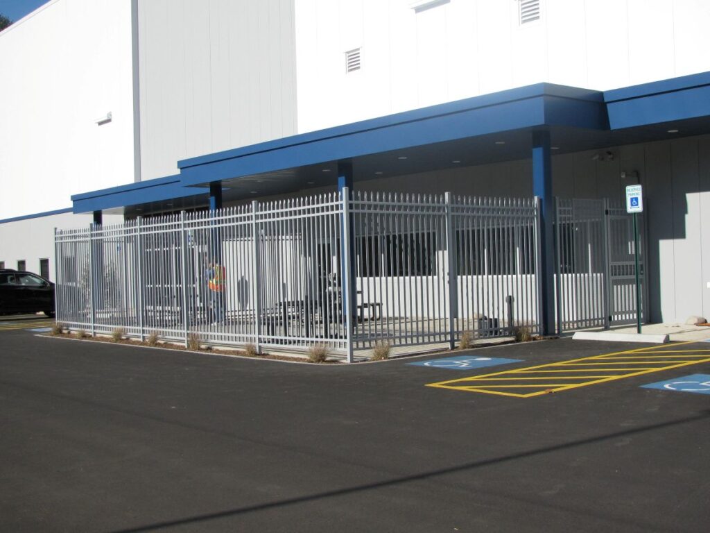 Metal fence in front of a warehouse