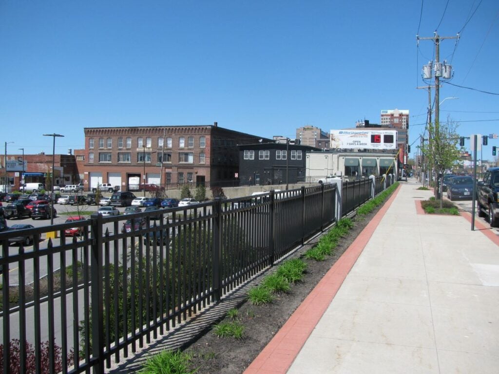 Black commercial fence surrounding a parking lot