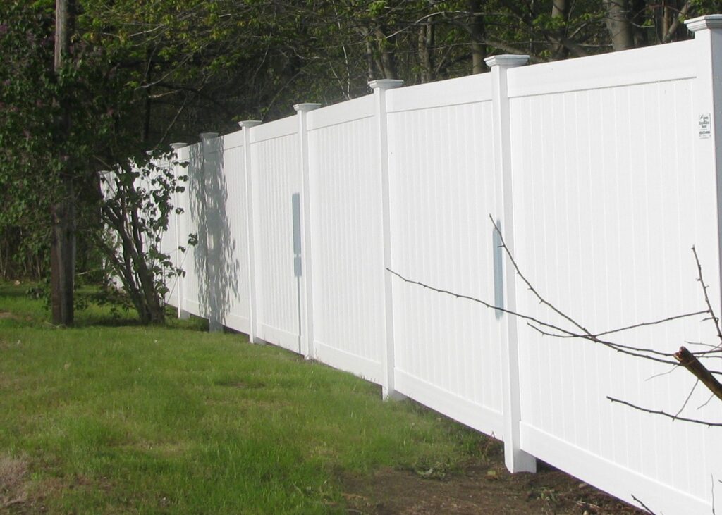 White privacy vinyl fence in a backyard