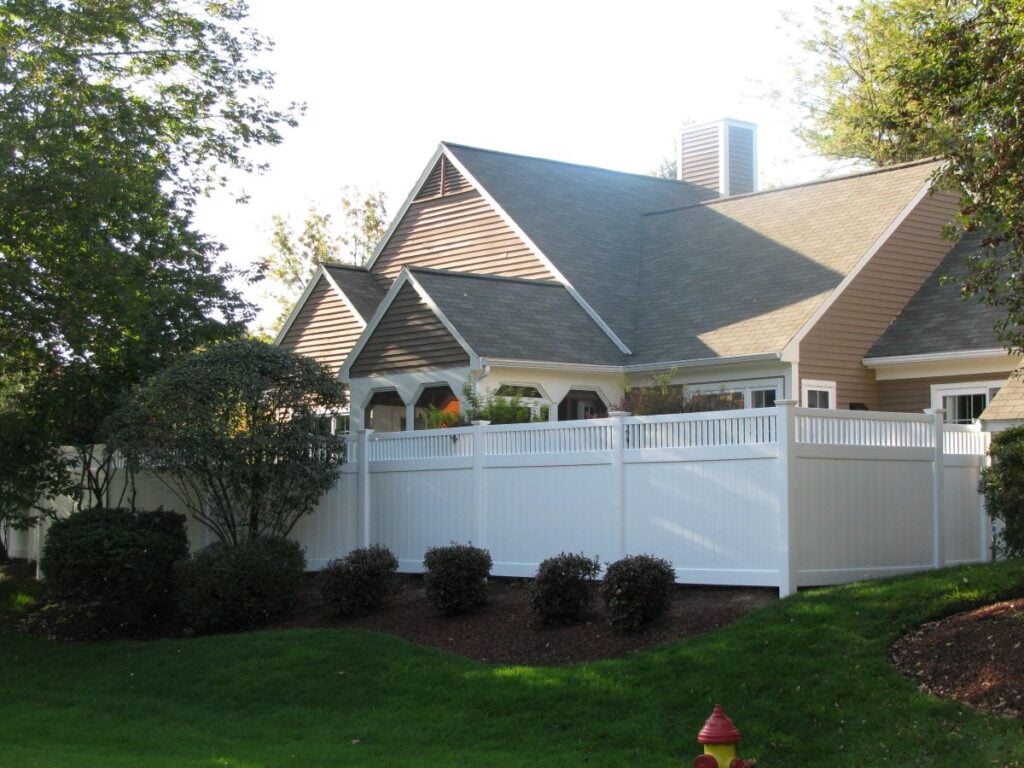 House with a white vinyl fence
