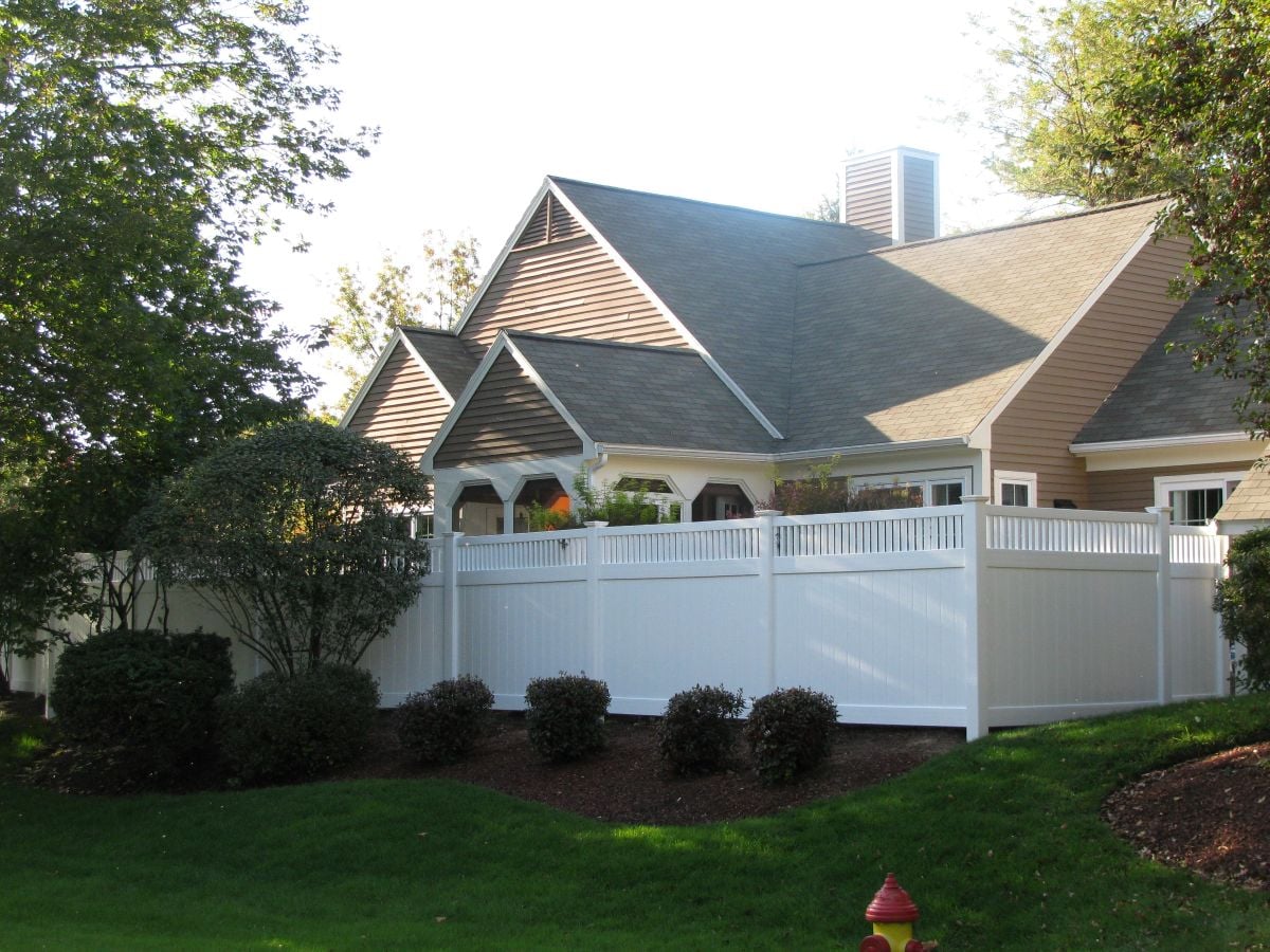 House with a white vinyl fence
