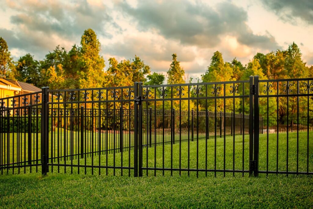 A new black metal fence in a backyard