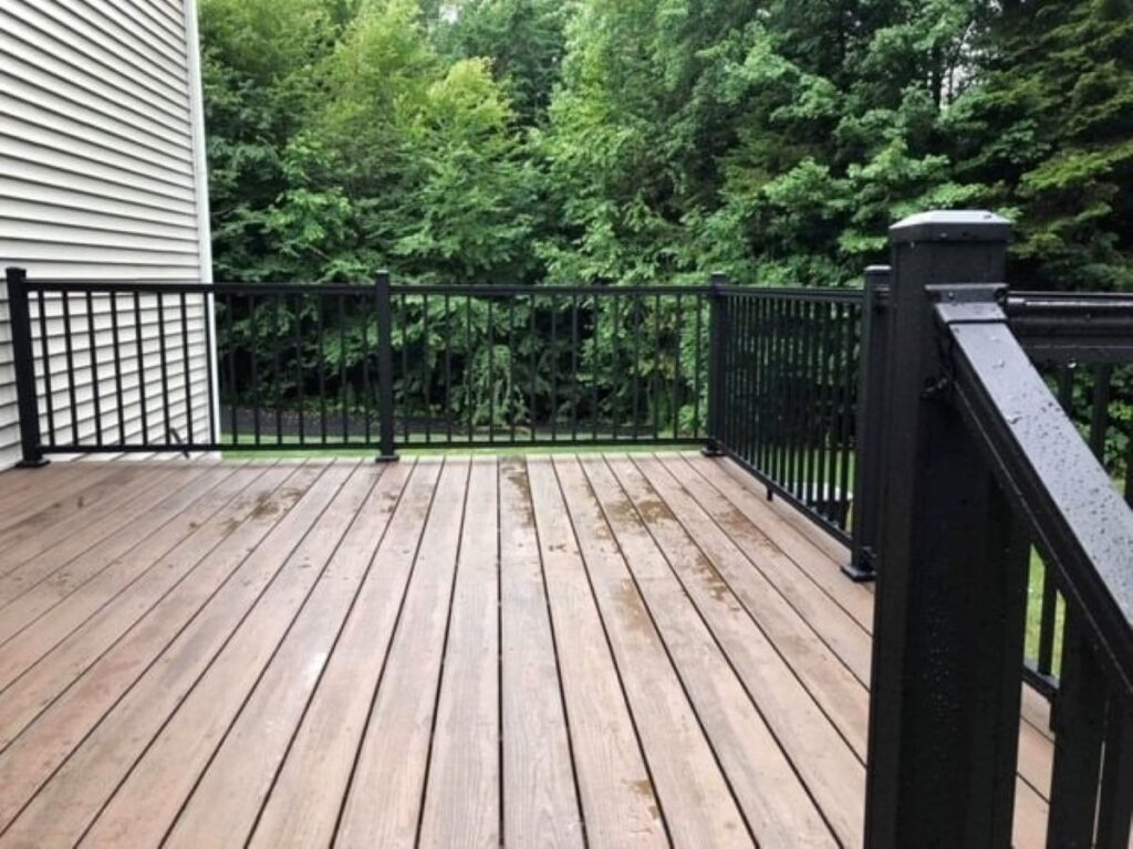 deck repair cost black fence synthetic wood floor deck surrounded by trees