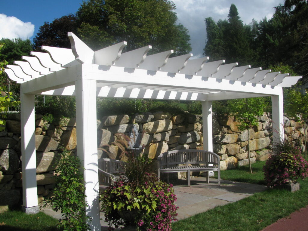 A white pergola in a garden