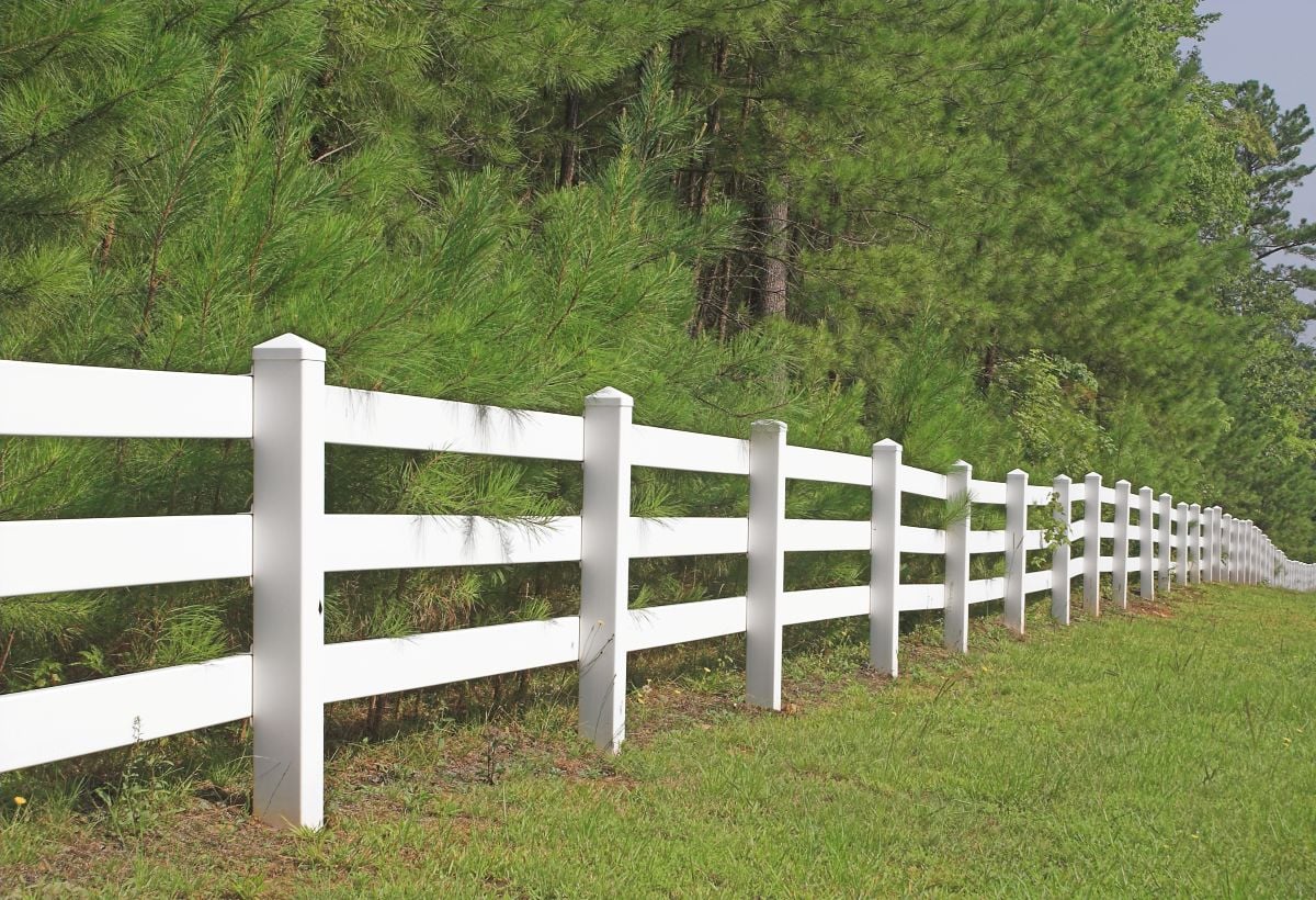 A decorative white split rail fence.