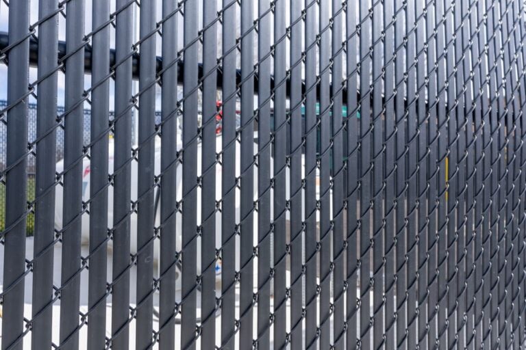 Black vinyl coated chain link fence with vertical black privacy slats