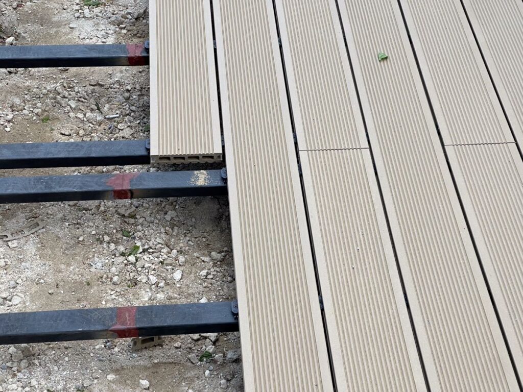 Installation process of wood plastic composite decking boards on metal joists frame