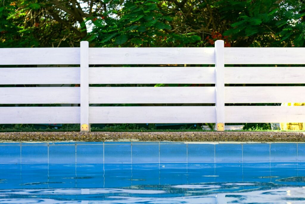 garden swimming pool site space fenced by wooden deck