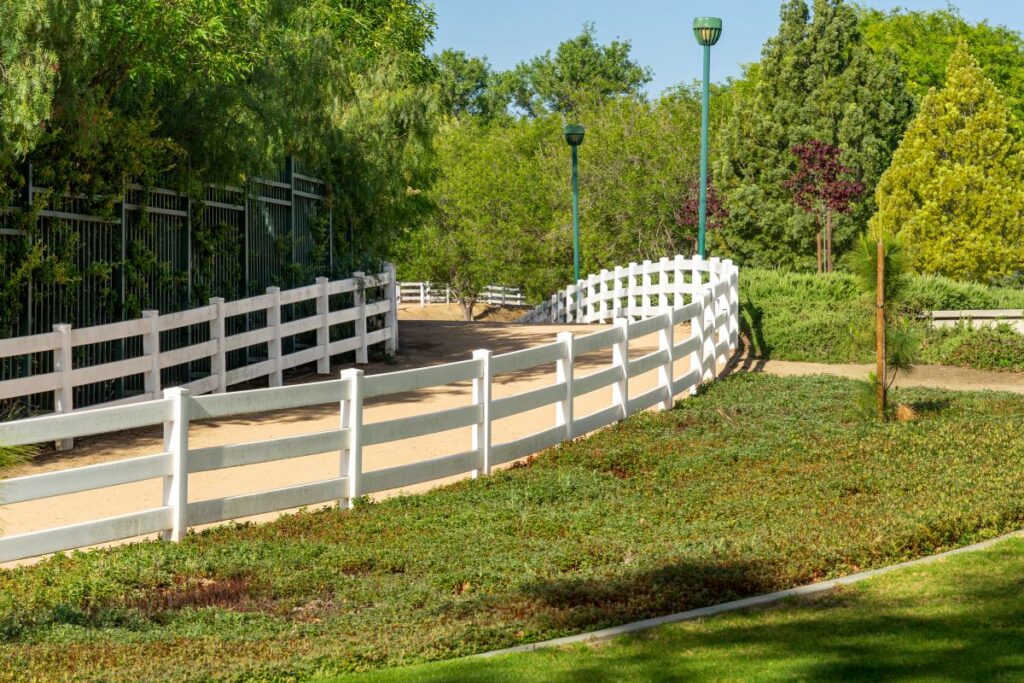 hiking and equestrian trail with a white vinyl rail fence